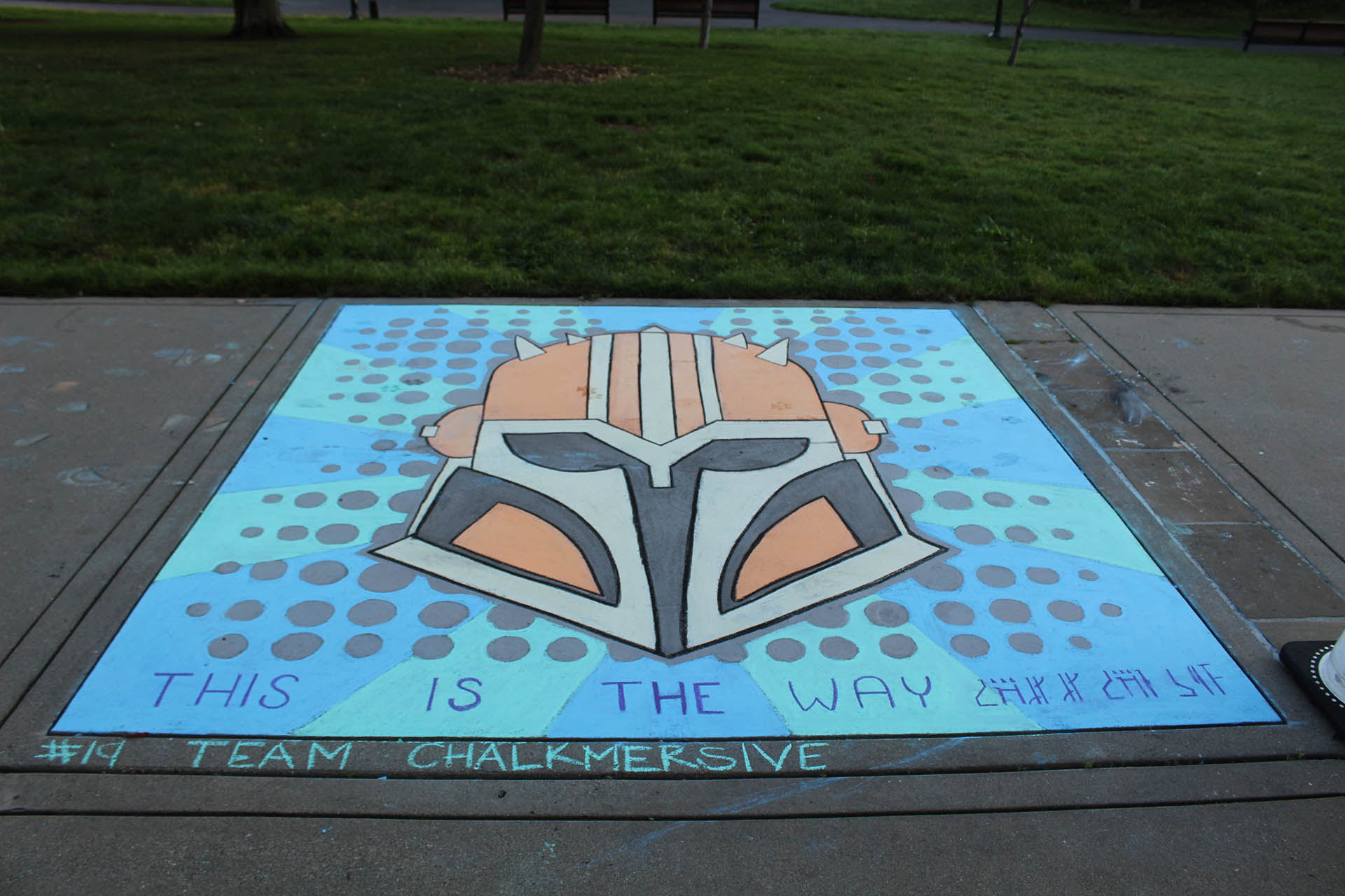 An entry from Lucasfilm Sidewalk Chalk Festival depicting the Armorer from The Mandalorian with 