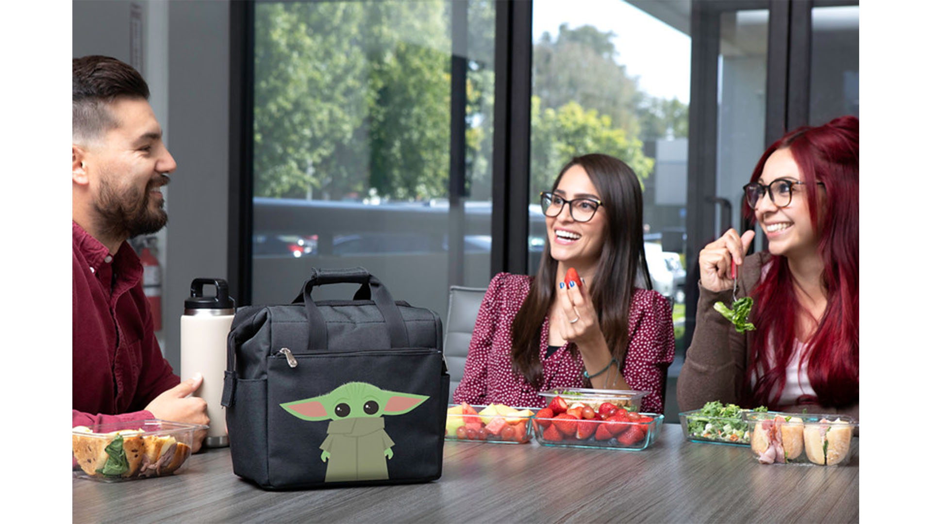 A group of three enjoys lunch from a Grogu lunchbox set inspired by Star Wars: The Mandalorian