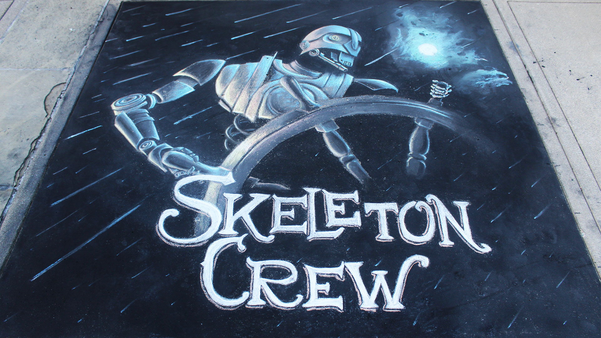 Chalk art of the droid from Skeleton Crew acts like a pirate at a ship's wheel.