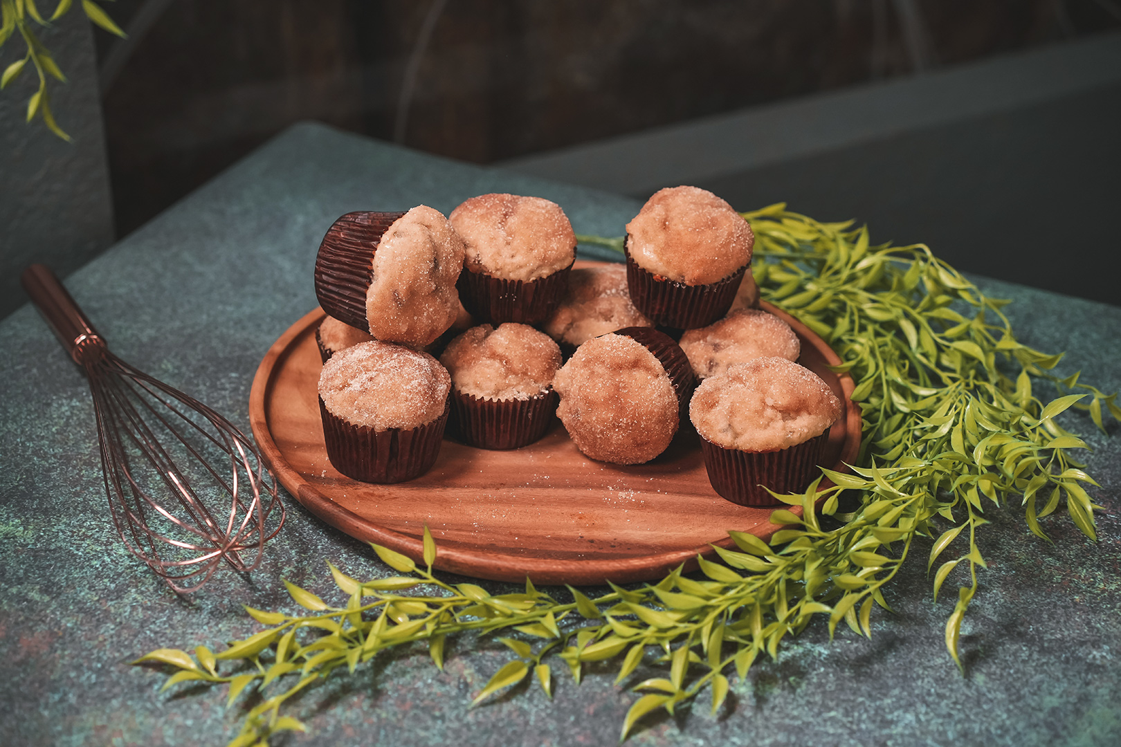 Dove's buttered muffins on a plate next to a whisk