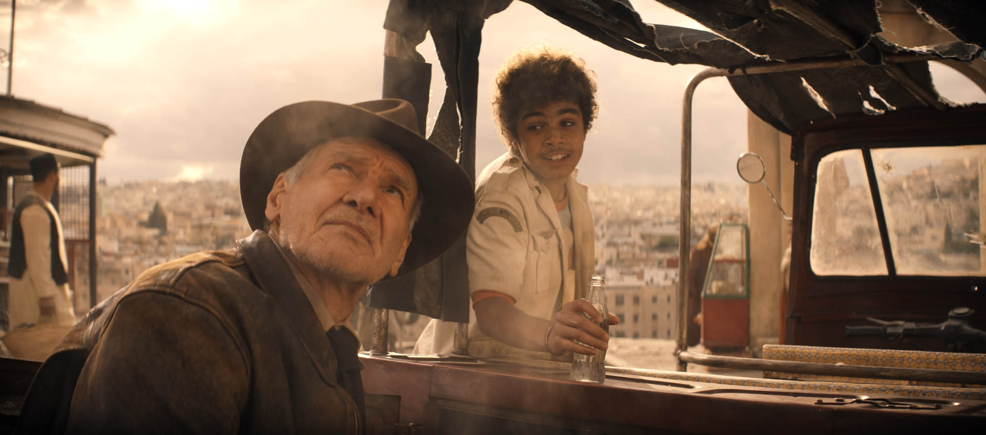 (L-R): Indiana Jones (Harrison Ford) and Teddy (Ethann Isidore) in Lucasfilm's INDIANA JONES AND THE DIAL OF DESTINY.