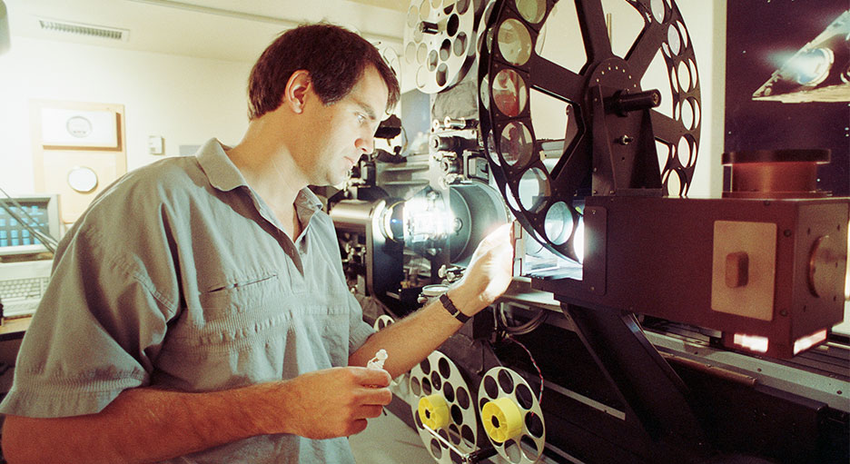 Compositor Jon Alexander works at an optical printer.