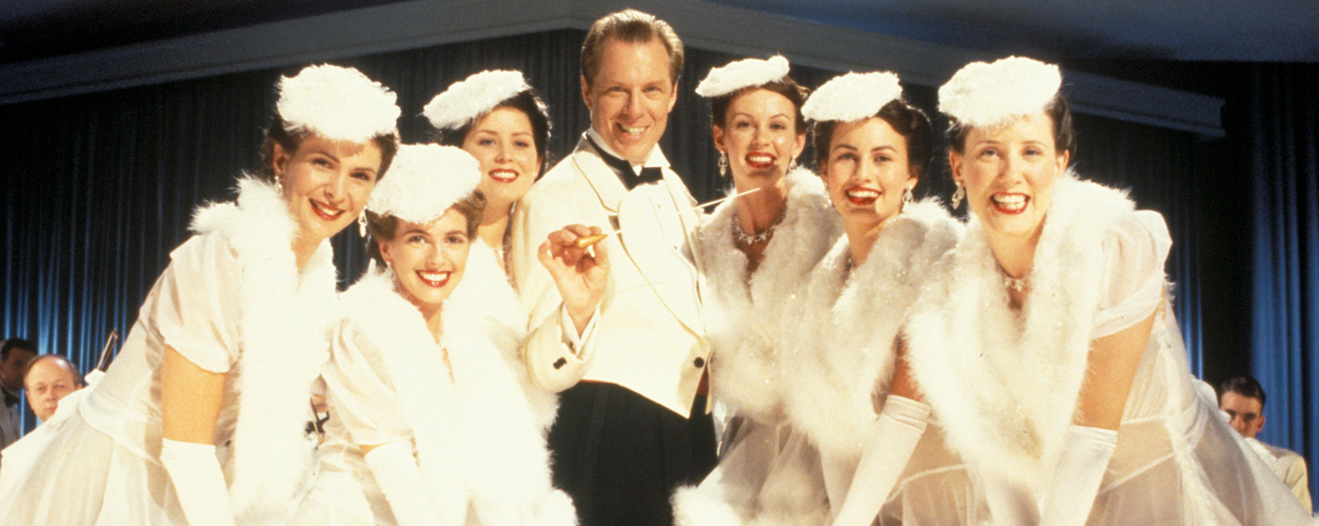 Bandleader Rick Rochester (Michael McKean) and dancers in Radioland Murders.