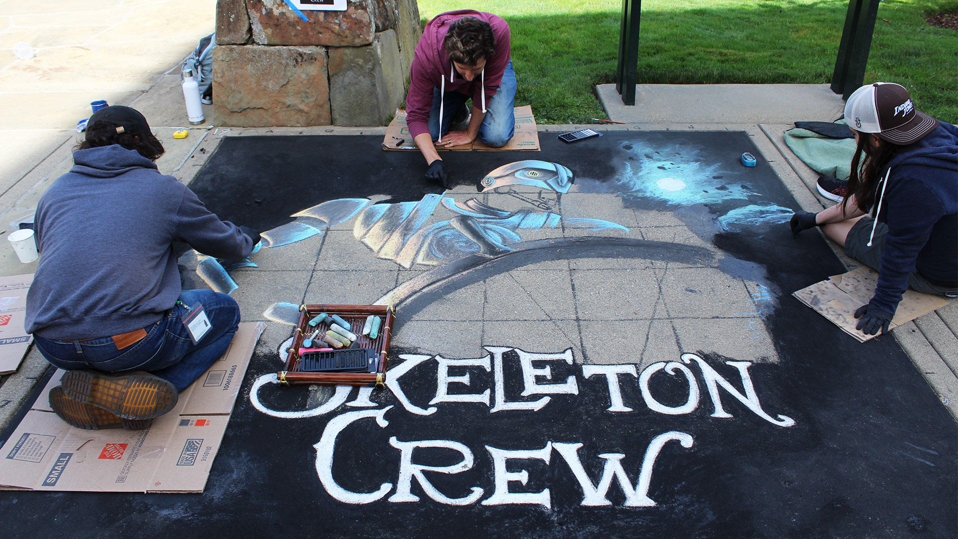 Employees creating art work at the Lucasfilm sidewalk chalk festival.