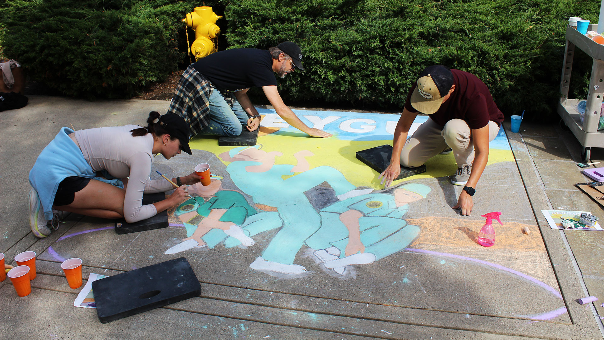 Employees creating art work at the Lucasfilm sidewalk chalk festival.