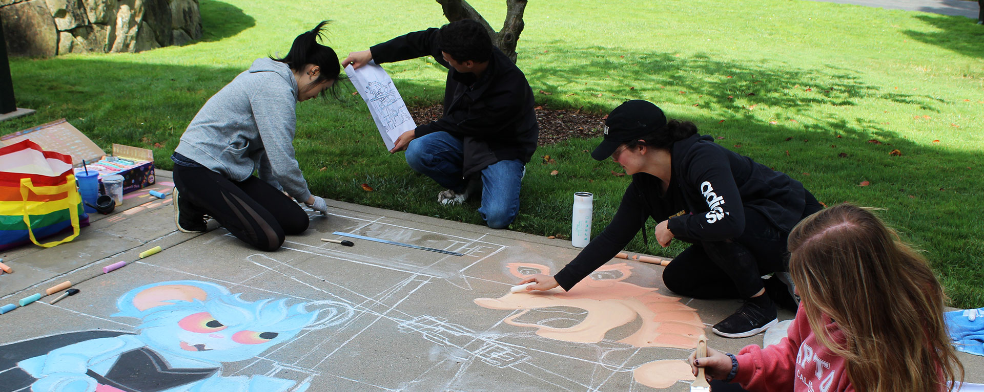 Employees creating art work at the Lucasfilm sidewalk chalk festival.