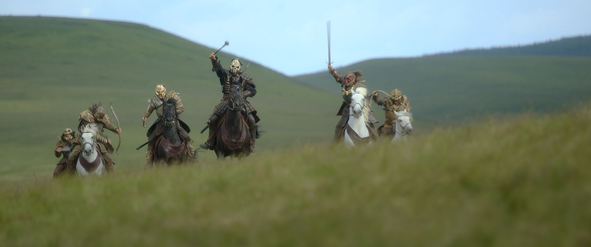 The skull-masked raiders chase the group on horseback.